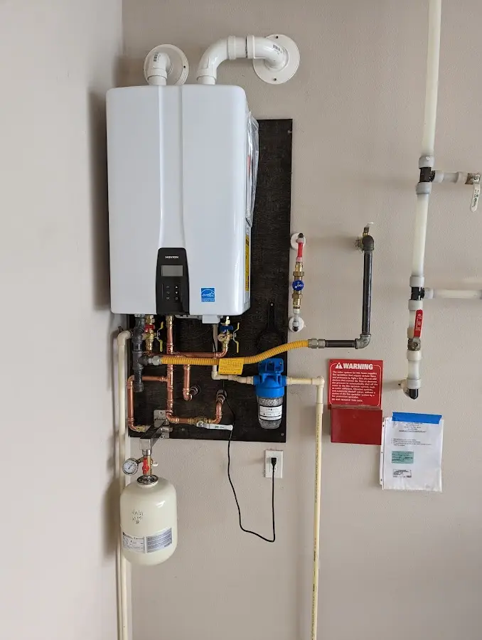 Professional plumber installing copper piping in a Dedham home